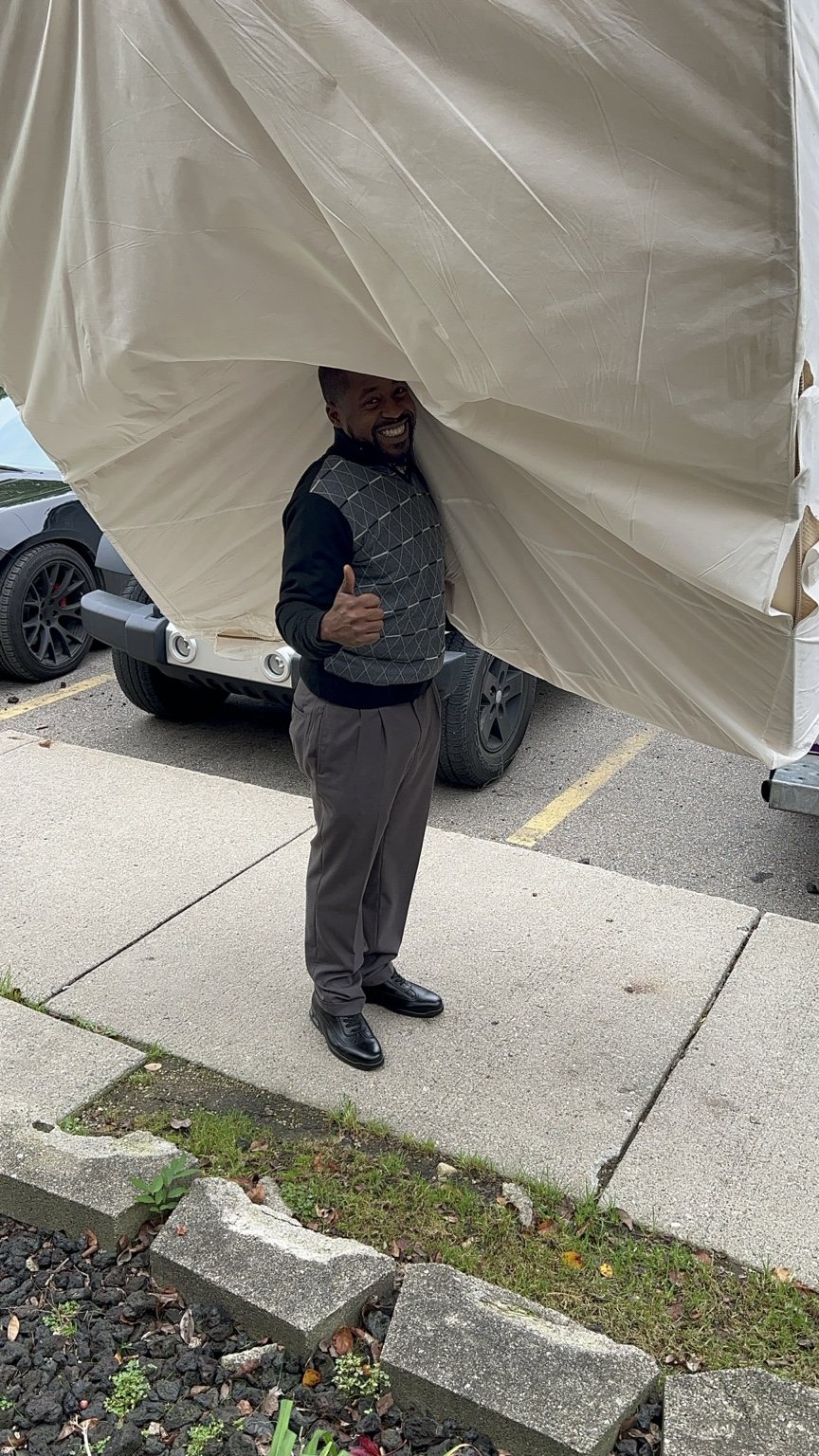 Grade A Movers handling a wrapped item during a Metro Detroit move